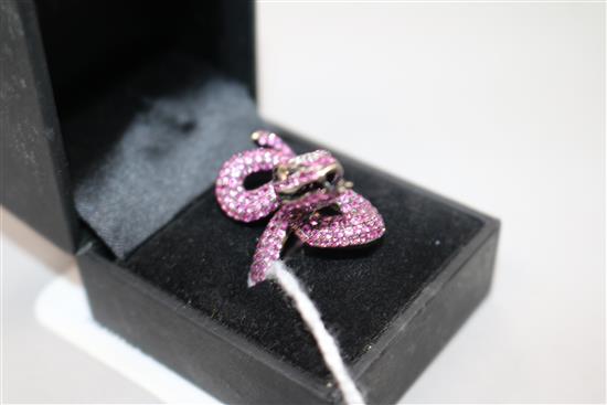 A modern blackened? gold, diamond and ruby encrusted serpent ring, size N.